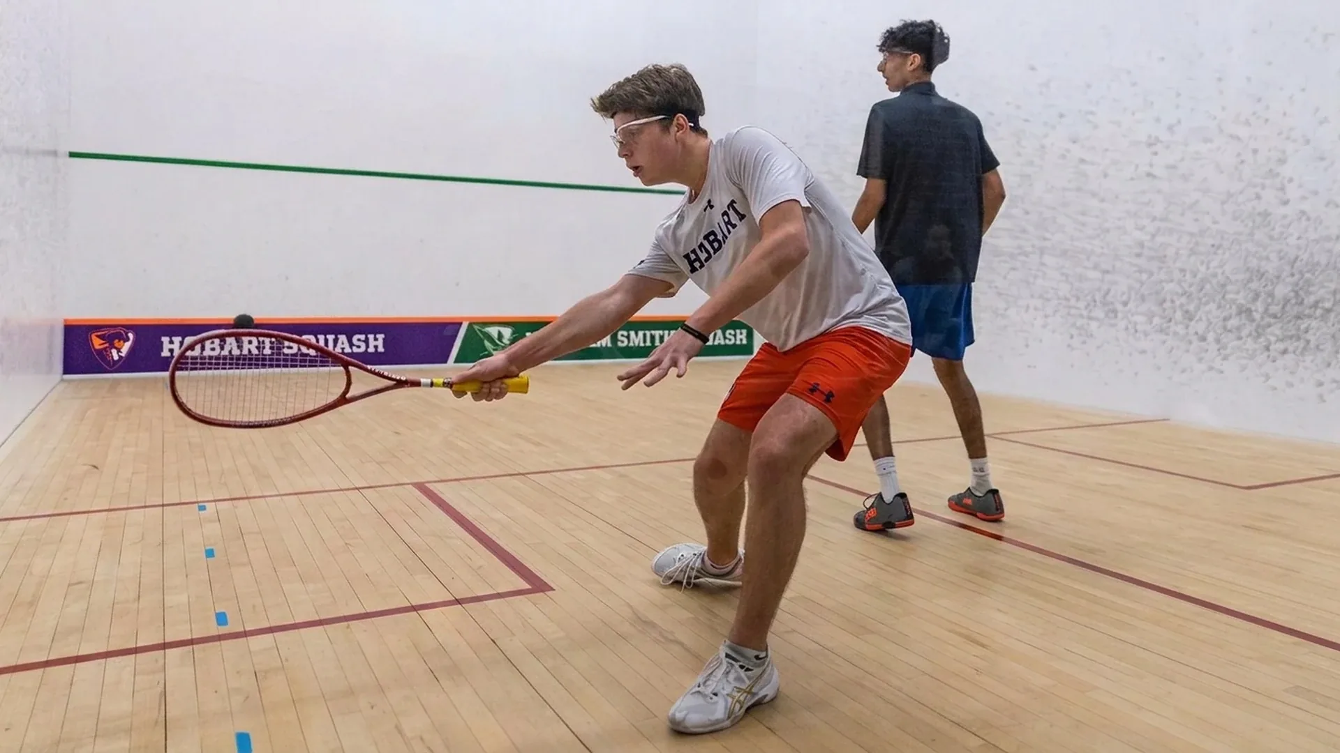 Squash players in action at Cross Court Squash